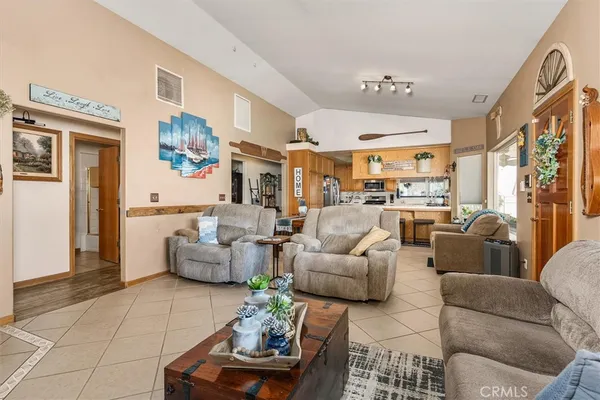 a living room with furniture fireplace and a large window