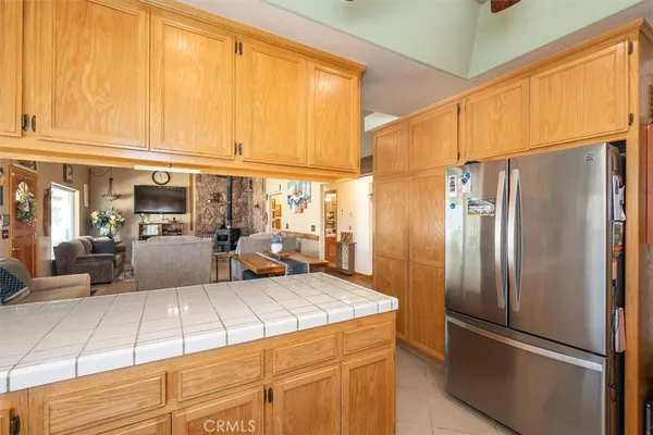 a kitchen with stainless steel appliances granite countertop a refrigerator and a stove