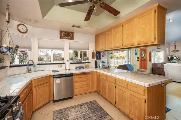 a kitchen with a sink window and cabinets