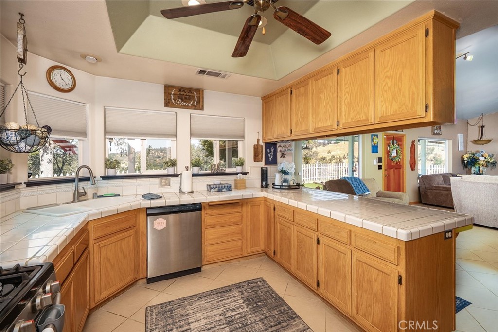 46455 Konklin Road Coarsegold, CA 93614 - Photo 18 of 46 a kitchen with a sink window and cabinets