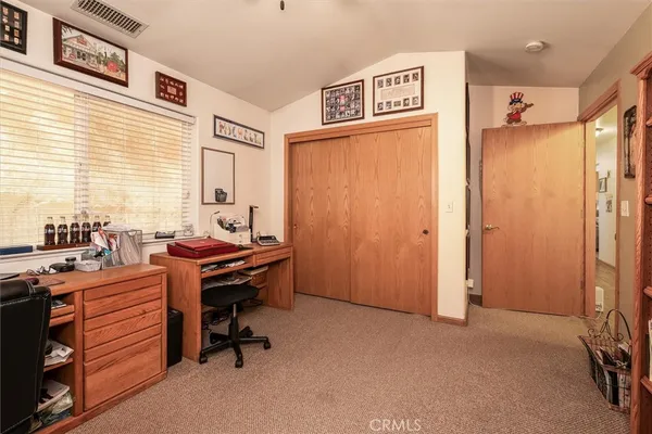 a view of a workspace with furniture and a window