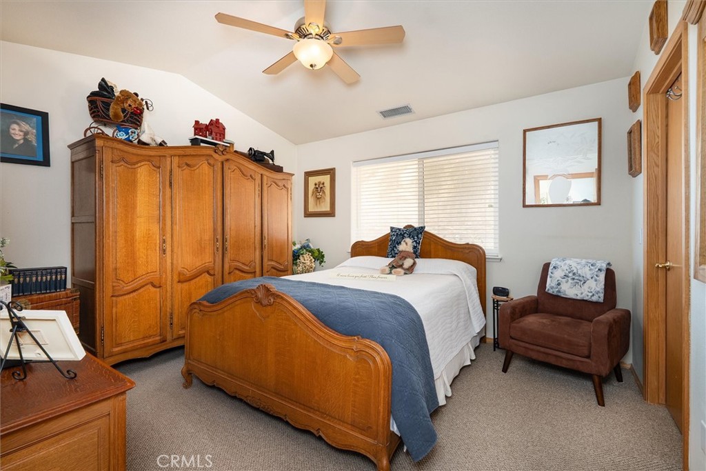46455 Konklin Road Coarsegold, CA 93614 - Photo 23 of 46 a bedroom with a bed and a chandelier