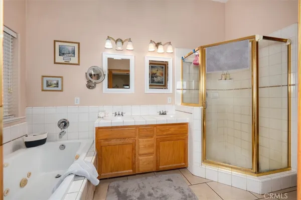 a bathroom with a tub sink and mirror
