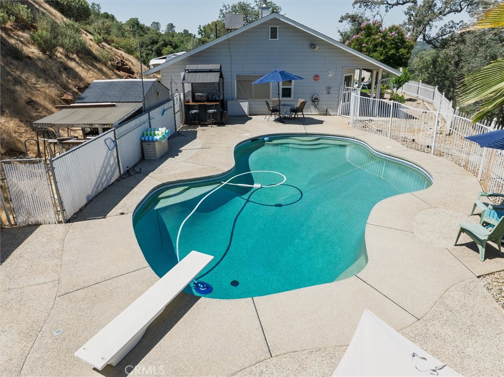 46455 Konklin Road Coarsegold, CA 93614 - Photo 34 of 46 a view of a white house with a swimming pool