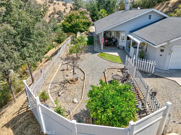 a view of a house with a patio and a garden