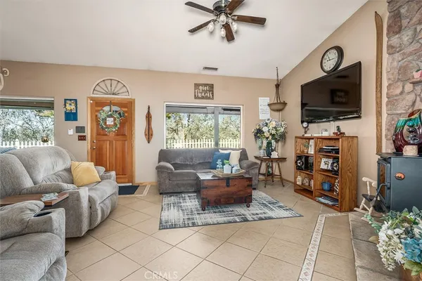 a living room with fireplace furniture and a flat screen tv