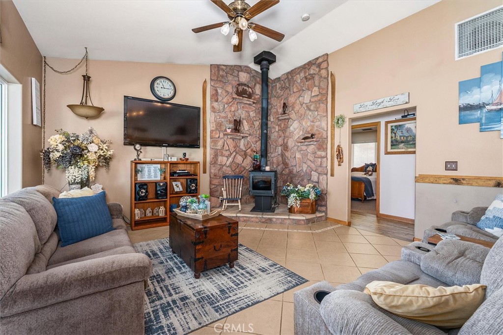 46455 Konklin Road Coarsegold, CA 93614 - Photo 7 of 46 a living room with furniture a flat screen tv and a fireplace