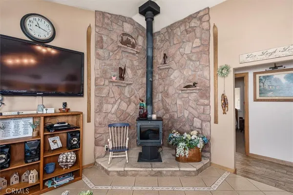 a living room with fireplace furniture and a flat screen tv