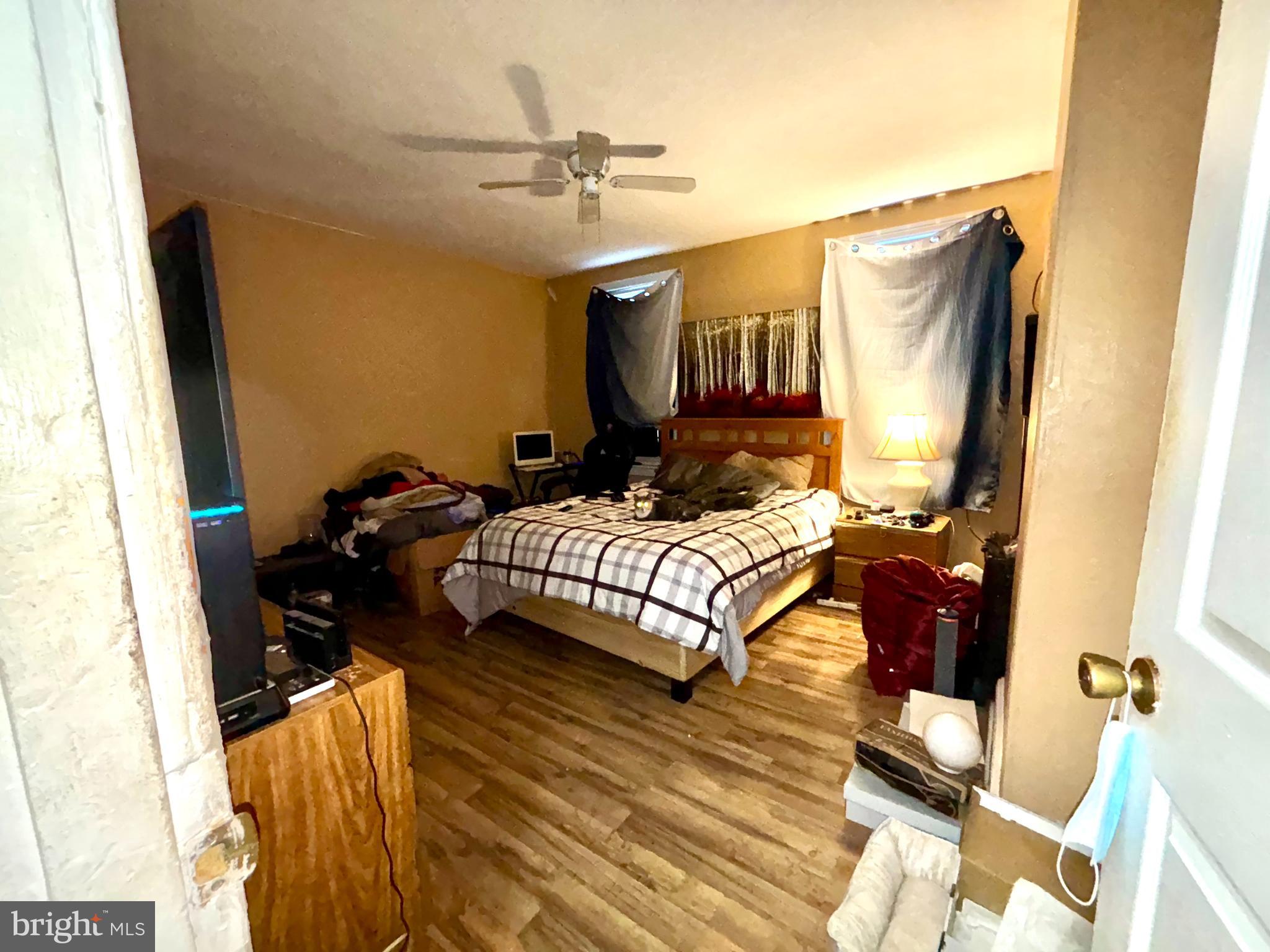 5144 West Stiles Street Philadelphia, PA 19131 - Photo 12 of 16 a bedroom with a bed and wooden floor