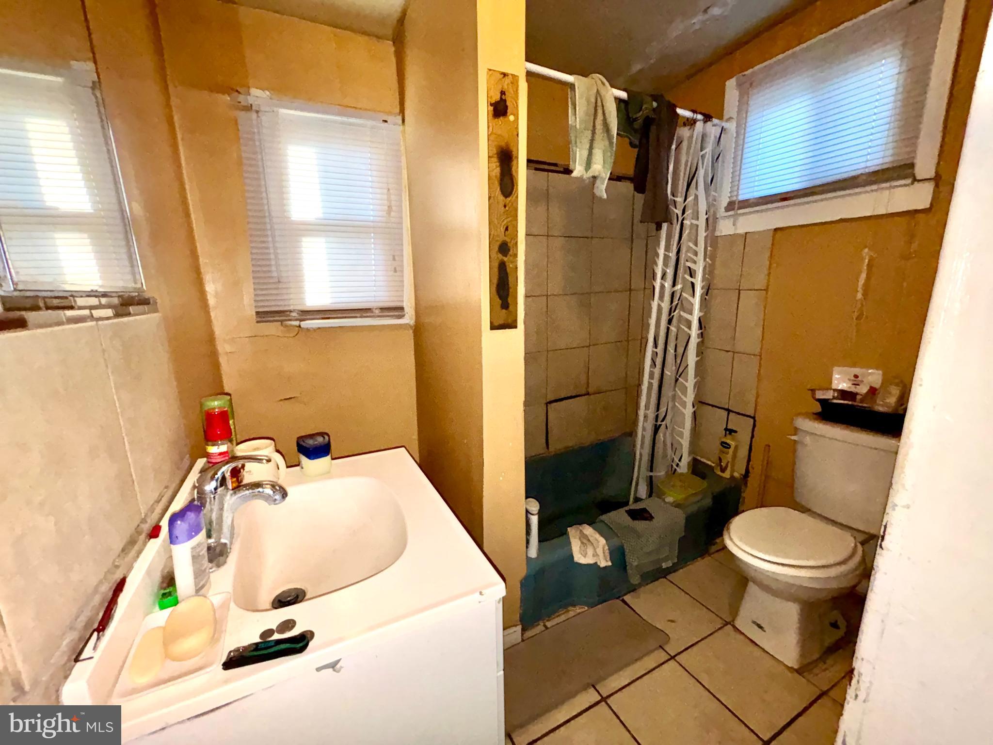 5144 West Stiles Street Philadelphia, PA 19131 - Photo 10 of 16 a bathroom with a sink toilet and shower