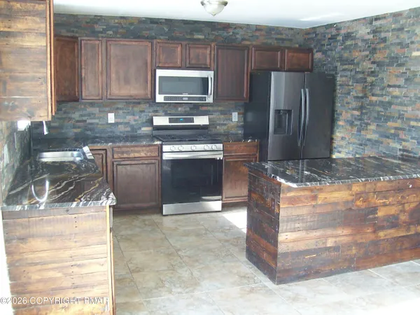 a view of a small space with wooden floor and a window