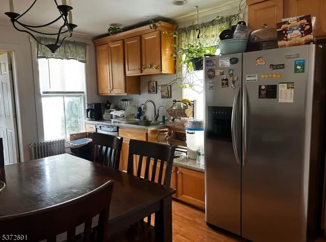 a kitchen with stainless steel appliances granite countertop a refrigerator a sink a stove and island