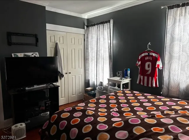 a bedroom with a bed and a chandelier