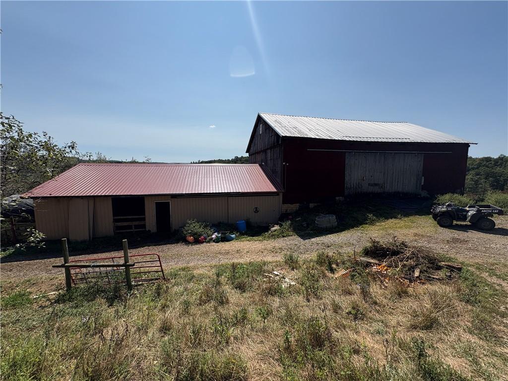294 Sprankle Road Punxsutawney, PA 15767 - Photo 6 of 28 a backyard of a house with table and chairs under an umbrella