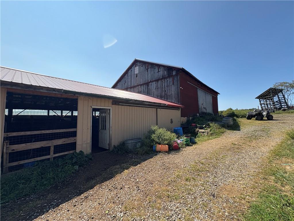 294 Sprankle Road Punxsutawney, PA 15767 - Photo 9 of 28 a backyard of a house with potted plants and brick wall