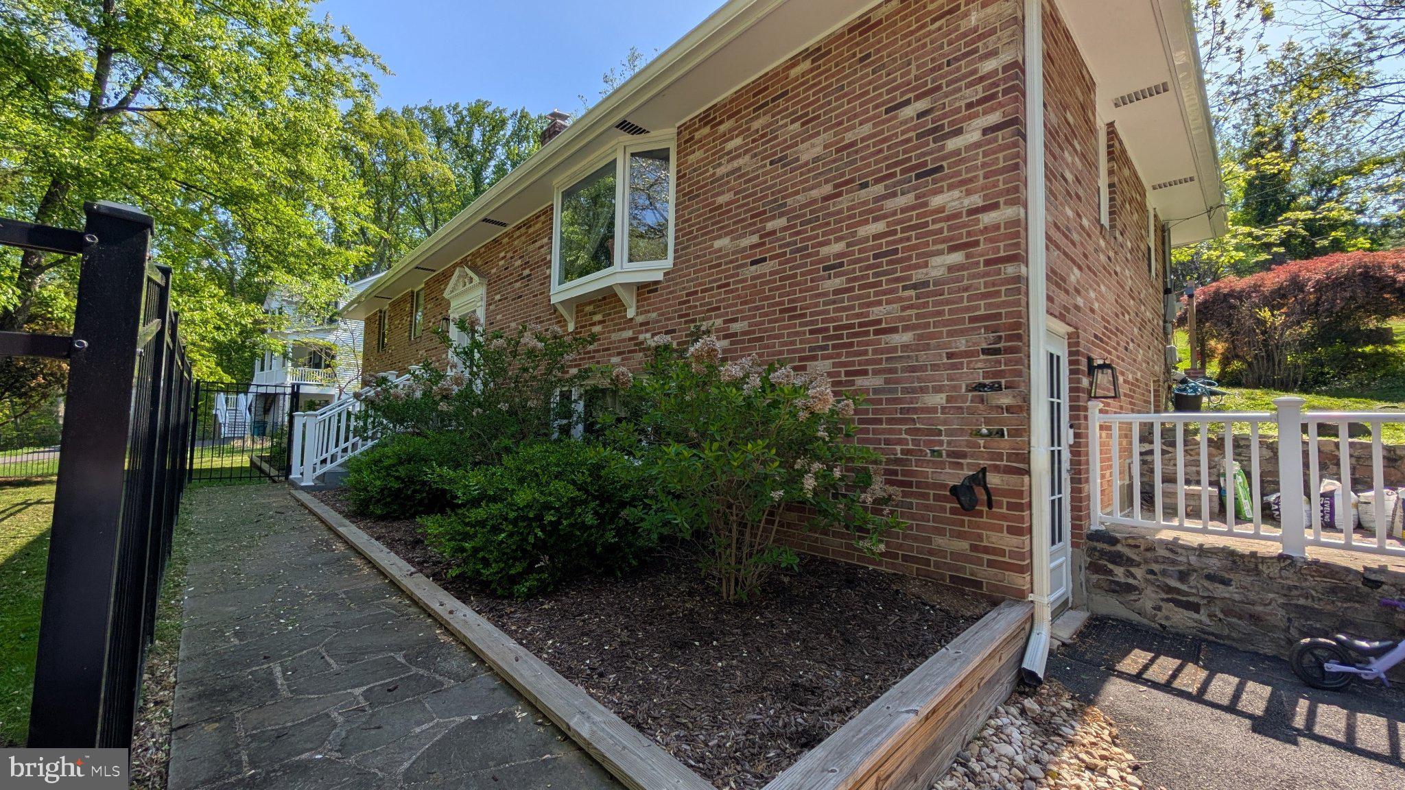 15715 Tierra Drive Silver Spring, MD 20906 - Photo 3 of 40 Charming brick home with lush greenery.