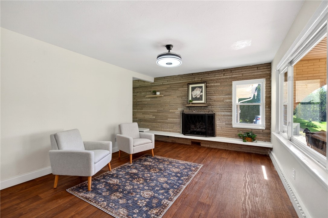 2684 Arthur Road Springfield, OH 45502 - Photo 12 of 69 This inviting living area features warm wood flooring and a classic stone fireplace.