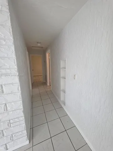 a view of an empty room and a window