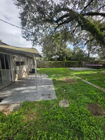 a view of a yard and front view of house