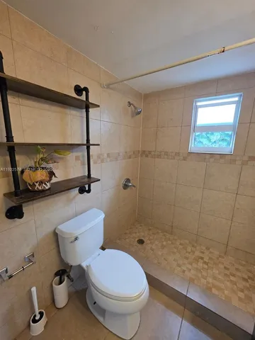 a bathroom with a toilet sink and shower