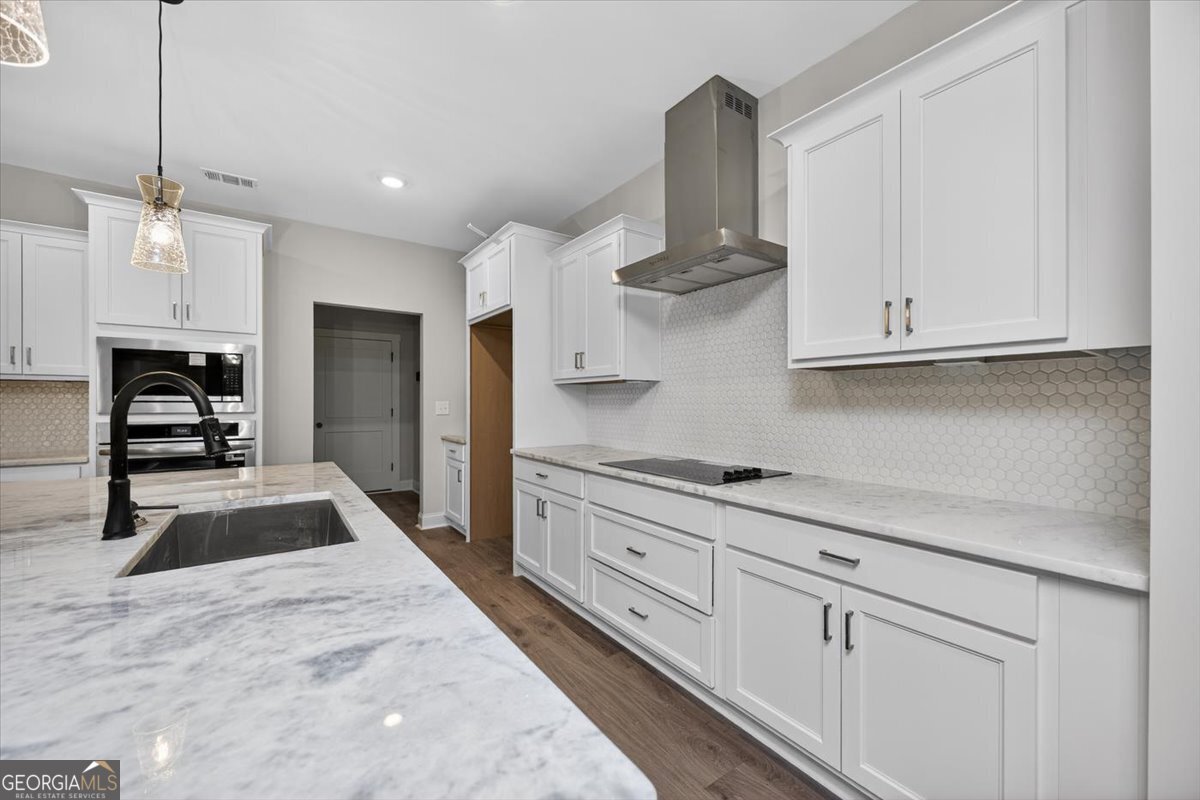 98 Mud Bridge Road The Rock, GA 30285 - Photo 13 of 47 a kitchen with granite countertop white cabinets and stainless steel appliances