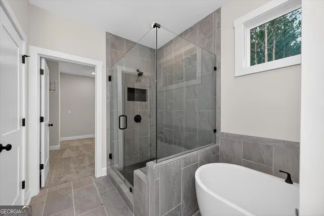 a bathroom with a tub and shower