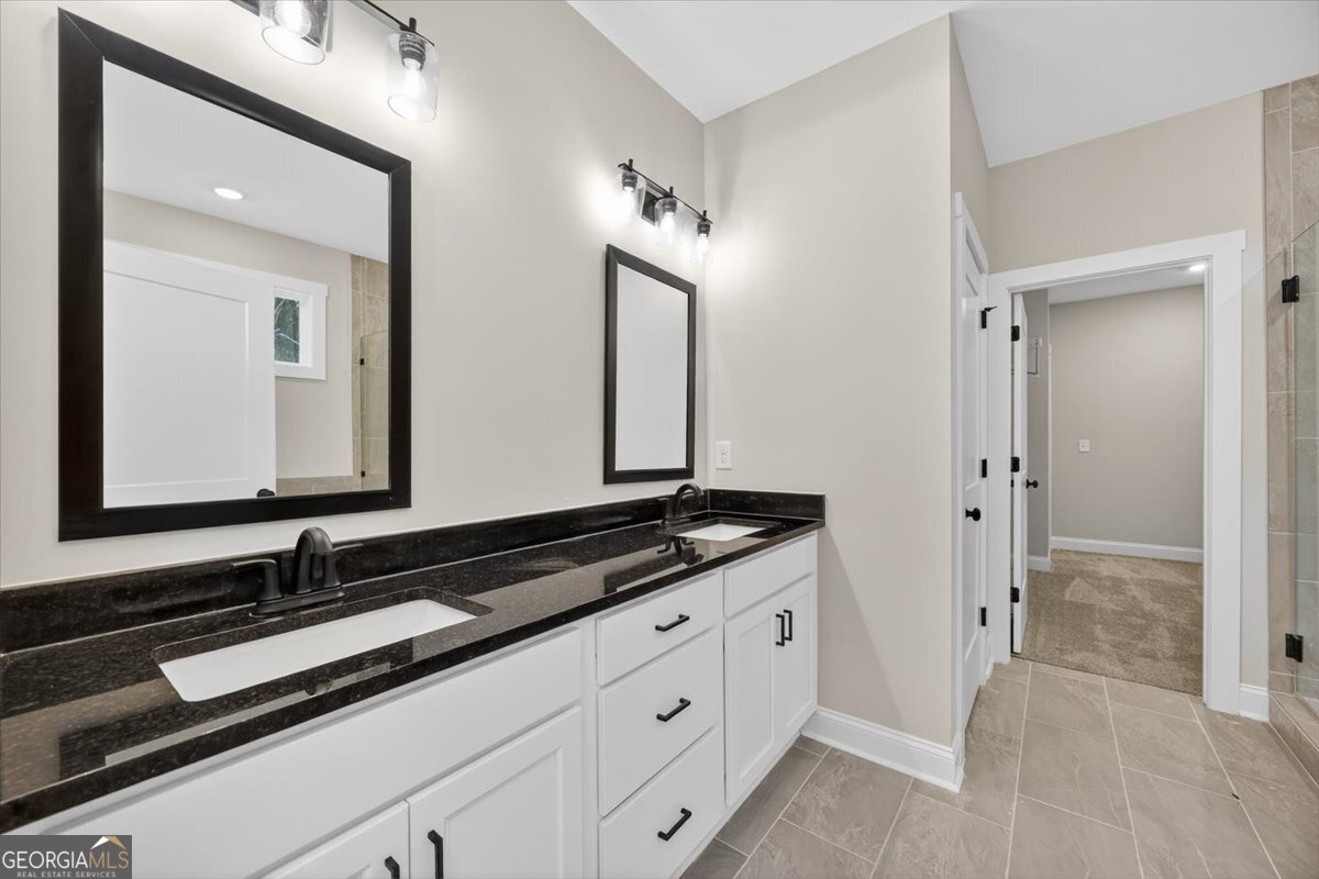 98 Mud Bridge Road The Rock, GA 30285 - Photo 20 of 47 a bathroom with a granite countertop sink and a mirror