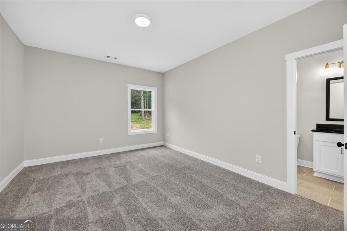 98 Mud Bridge Road The Rock, GA 30285 - Photo 26 of 47 a view of an empty room with window and kitchen view