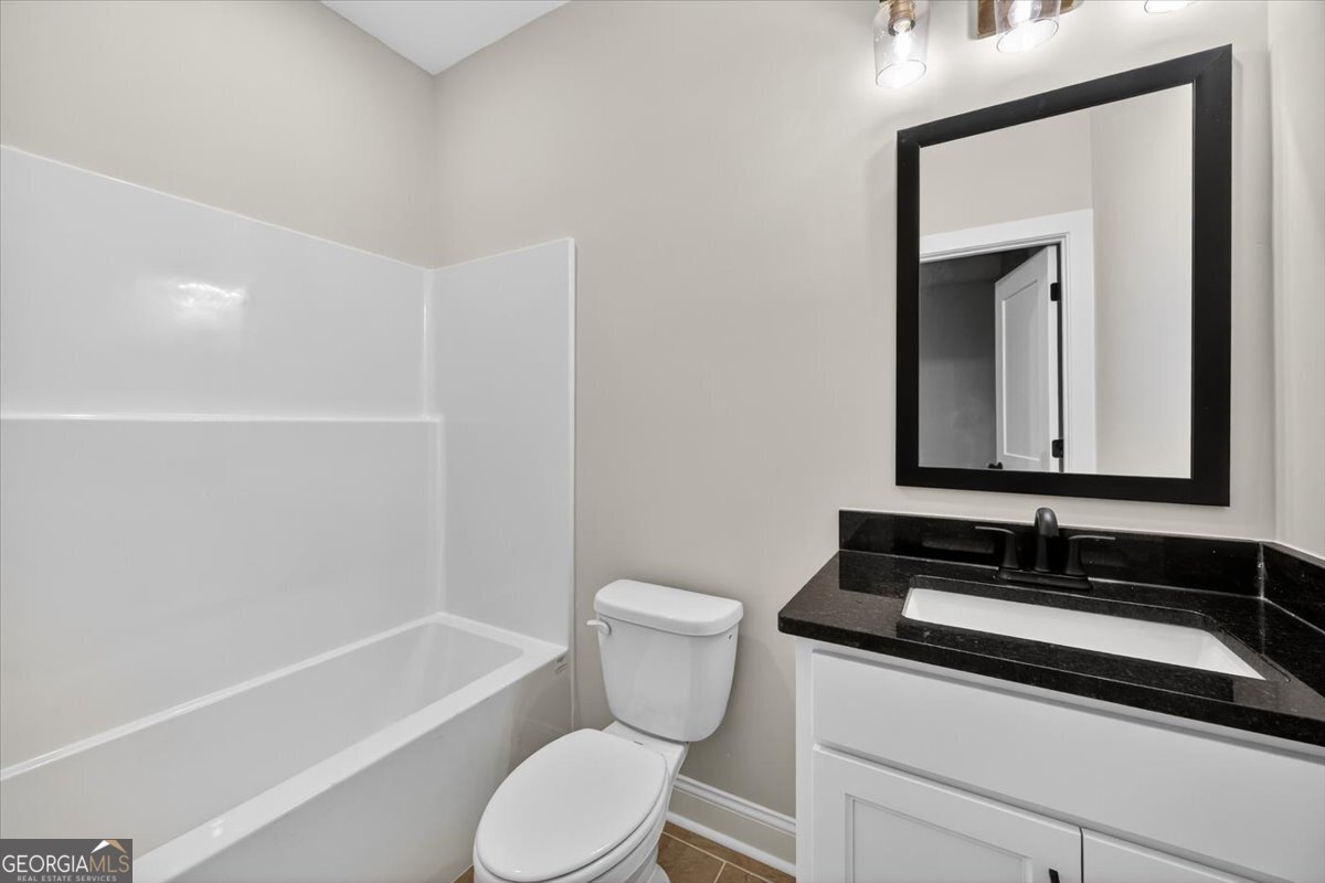 98 Mud Bridge Road The Rock, GA 30285 - Photo 28 of 47 a bathroom with a sink a toilet and shower