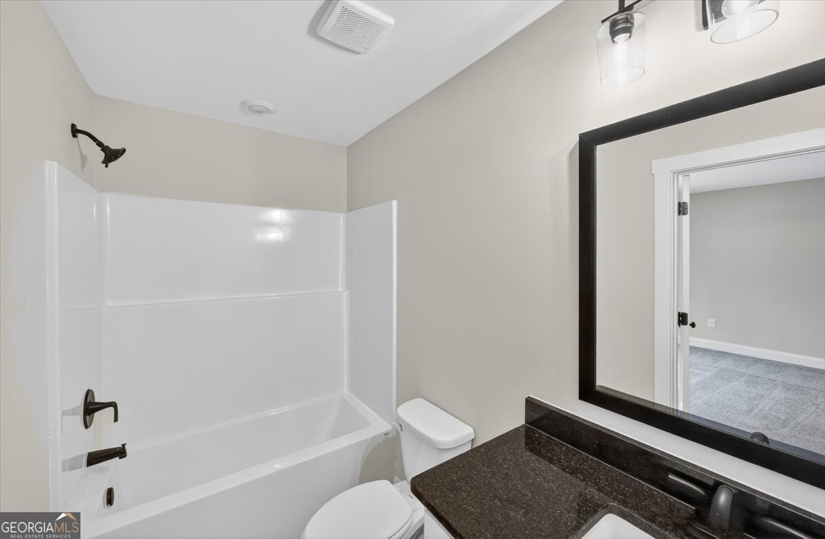 98 Mud Bridge Road The Rock, GA 30285 - Photo 32 of 47 a bathroom with a bathtub cabinets and a sink