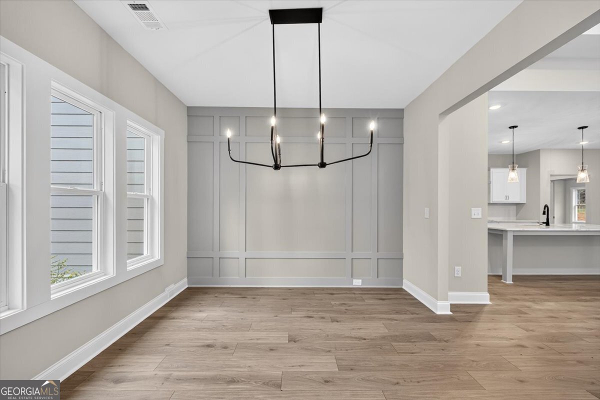 98 Mud Bridge Road The Rock, GA 30285 - Photo 6 of 47 a view of a room with wooden floor kitchen chandelier and windows
