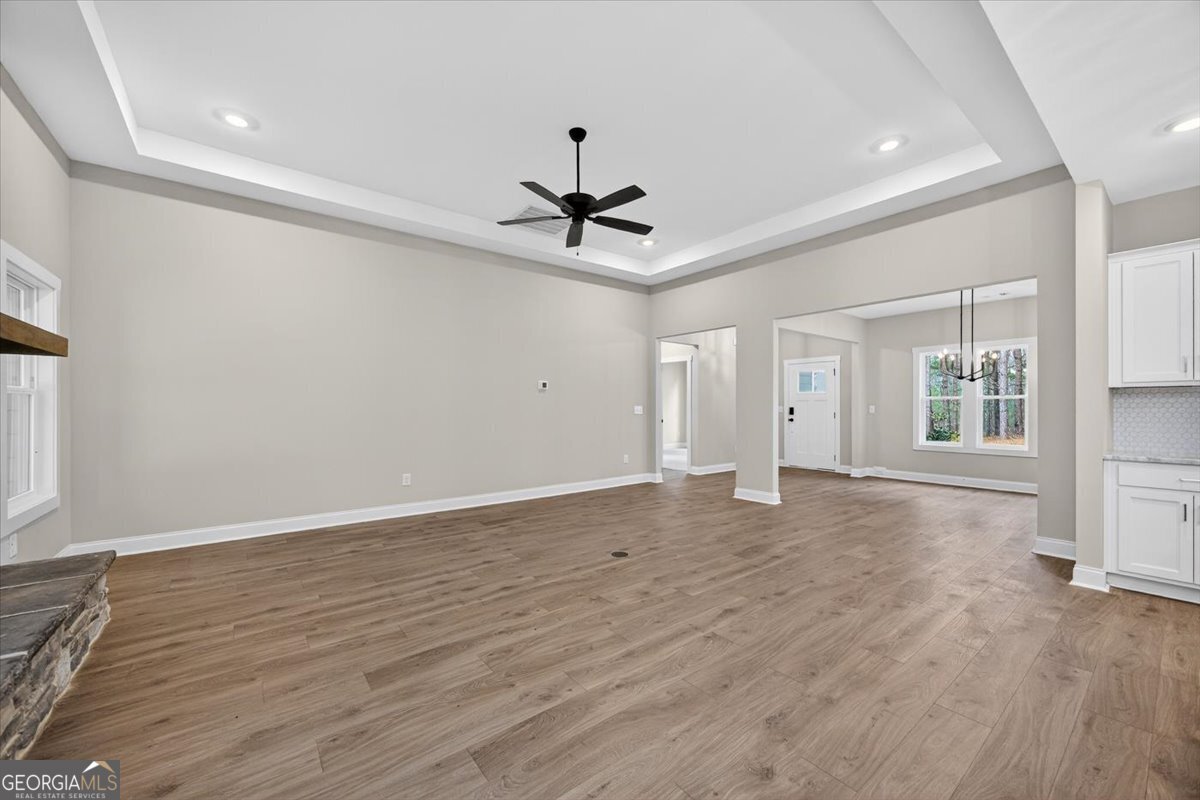 98 Mud Bridge Road The Rock, GA 30285 - Photo 9 of 47 a view of a livingroom with a ceiling fan wooden floor and a ceiling fan