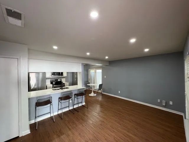 a kitchen with stainless steel appliances kitchen island a sink stove and refrigerator