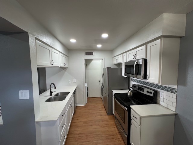 3511 Alpine Circle, Unit 2 Austin, TX 78704 - Photo 8 of 16 a kitchen with stainless steel appliances kitchen island a sink stove and refrigerator