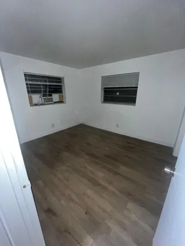 an empty room with wooden floor
