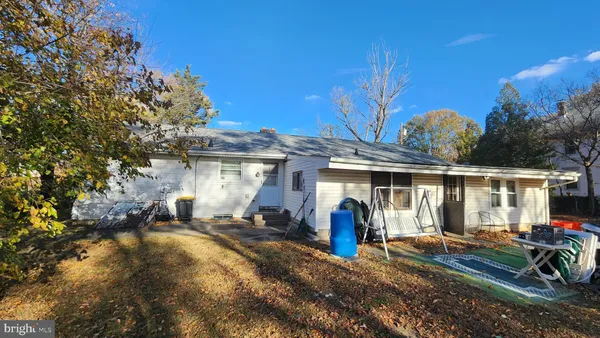 a front view of house with yard outdoor seating and barbeque oven
