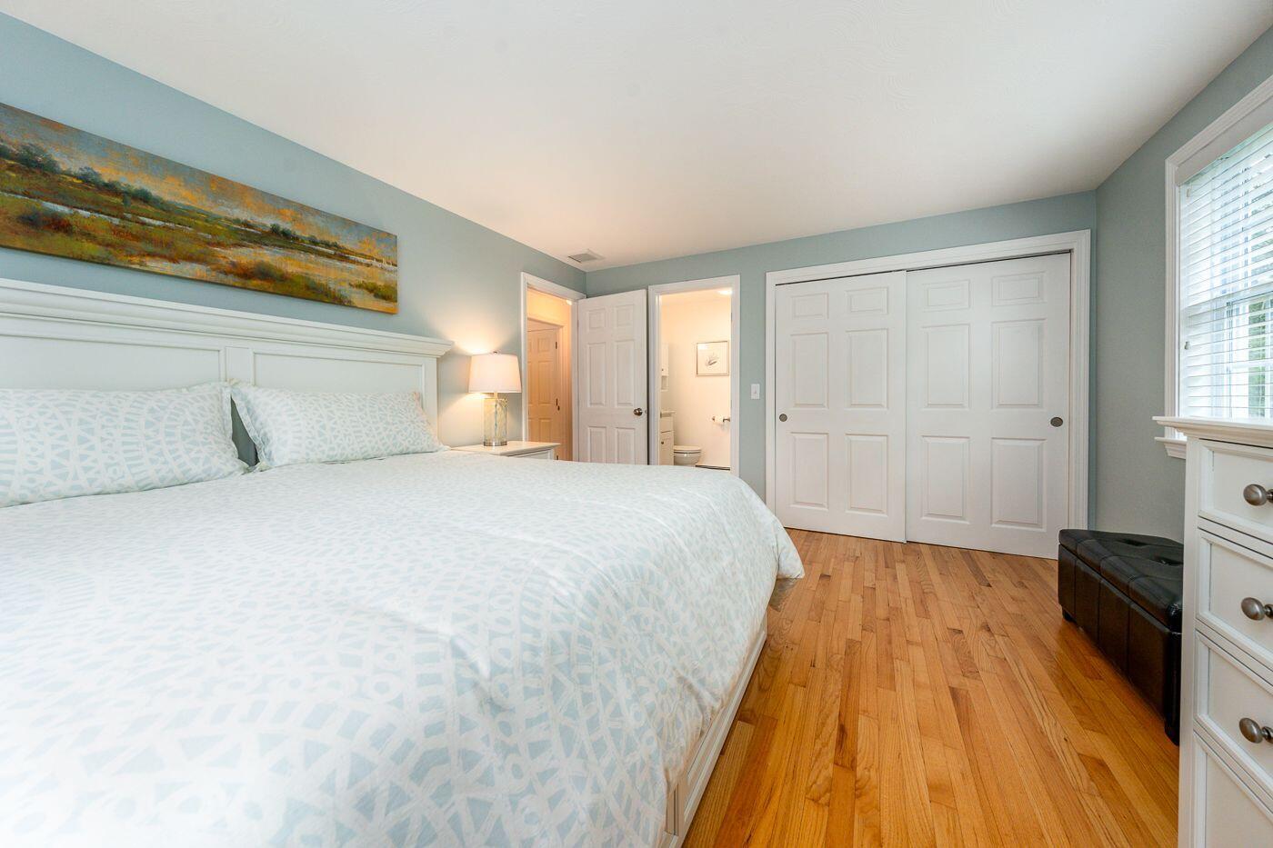 98 Valley Brook Road Centerville, MA 02632 - Photo 11 of 35 a spacious bedroom with a bed and wooden floor
