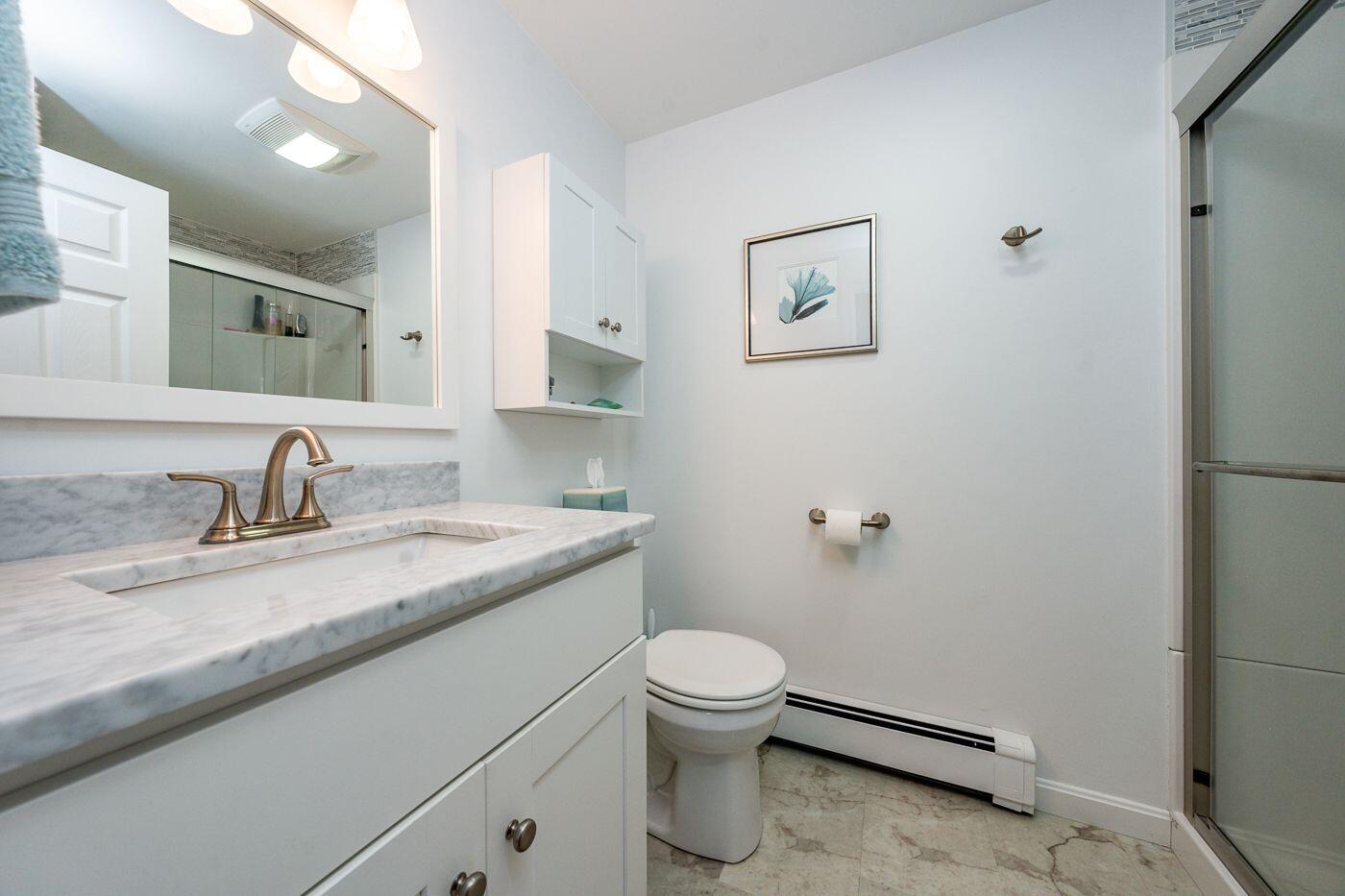 98 Valley Brook Road Centerville, MA 02632 - Photo 13 of 35 a bathroom with a granite countertop sink a toilet and a mirror