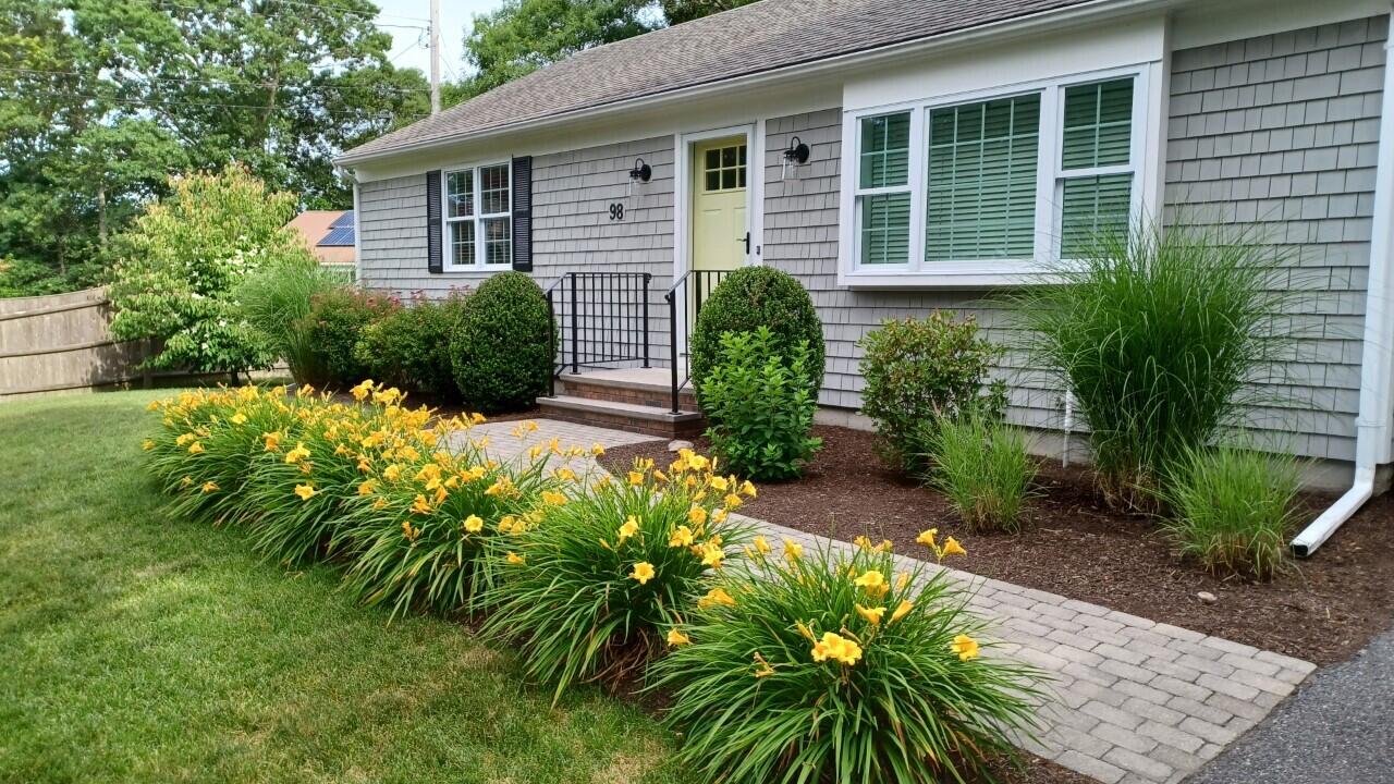 98 Valley Brook Road Centerville, MA 02632 - Photo 31 of 35 a front view of a house with a yard