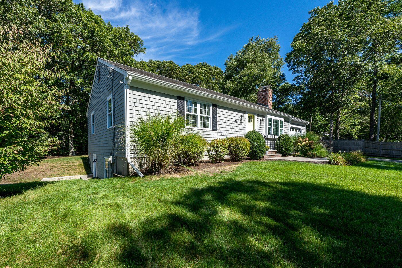 98 Valley Brook Road Centerville, MA 02632 - Photo 33 of 35 a view of a house with a yard and plants