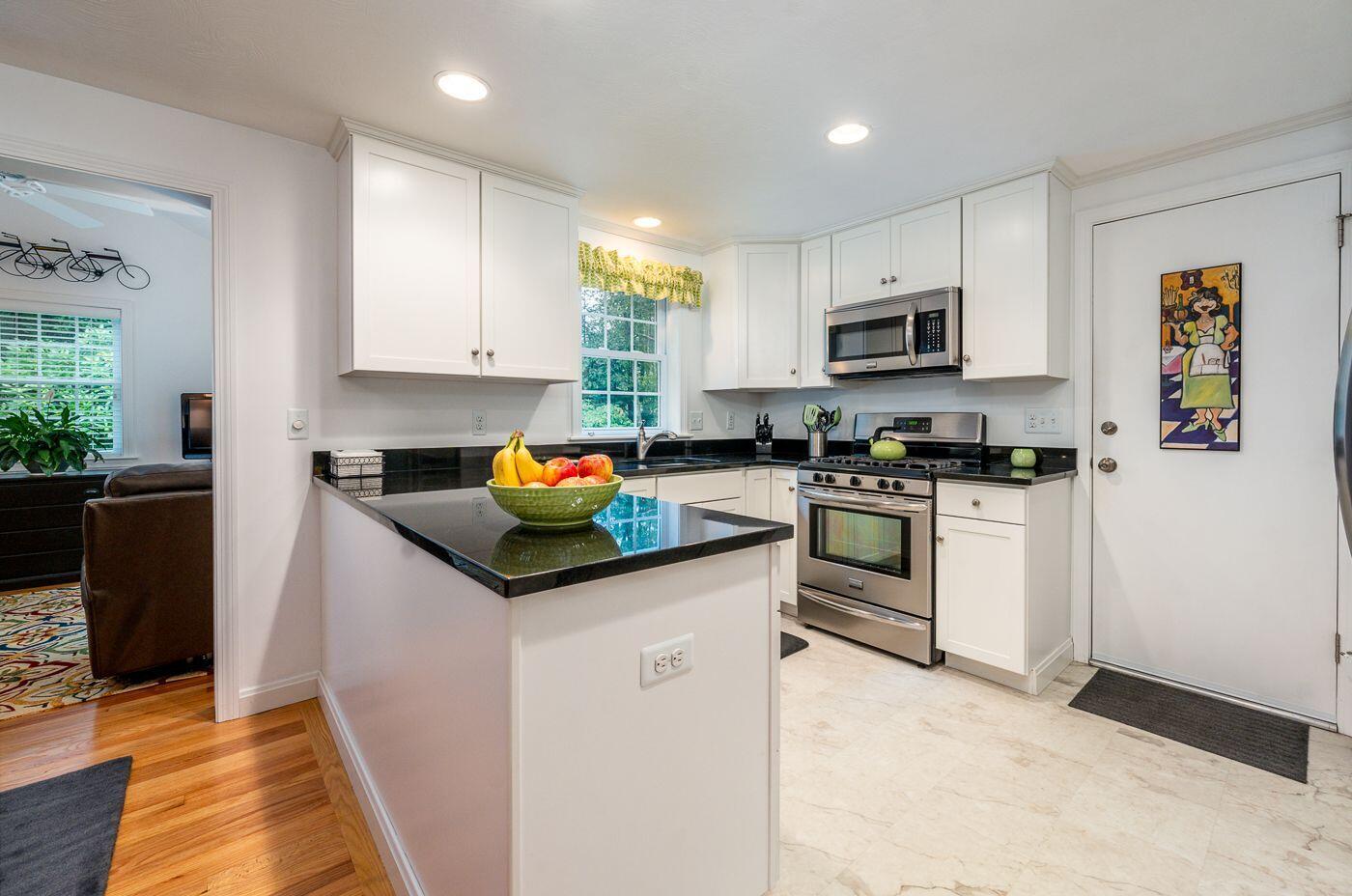98 Valley Brook Road Centerville, MA 02632 - Photo 8 of 35 a kitchen with granite countertop a sink and white cabinets