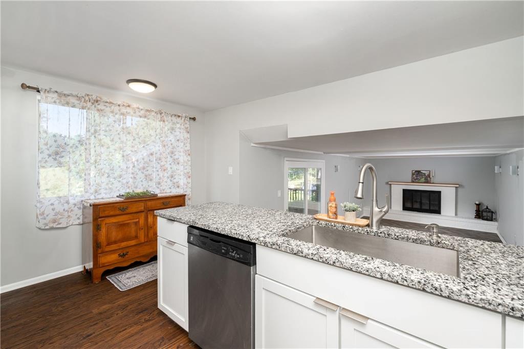 809 West Old Rte 422 Butler, PA 16001 - Photo 7 of 31 a kitchen with granite countertop kitchen island granite countertop a sink and dishwasher a oven with wooden cabinets