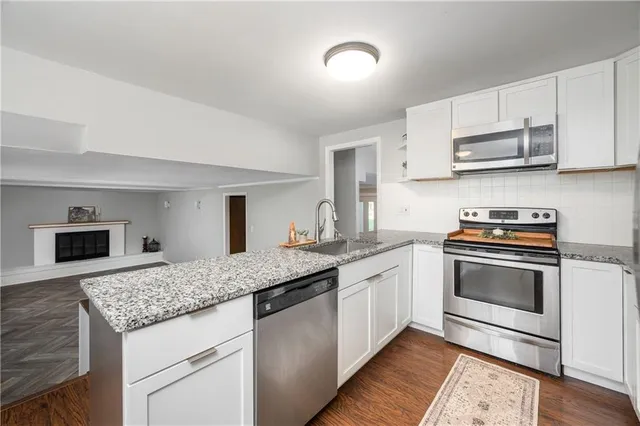 a kitchen with stainless steel appliances granite countertop a stove and a sink