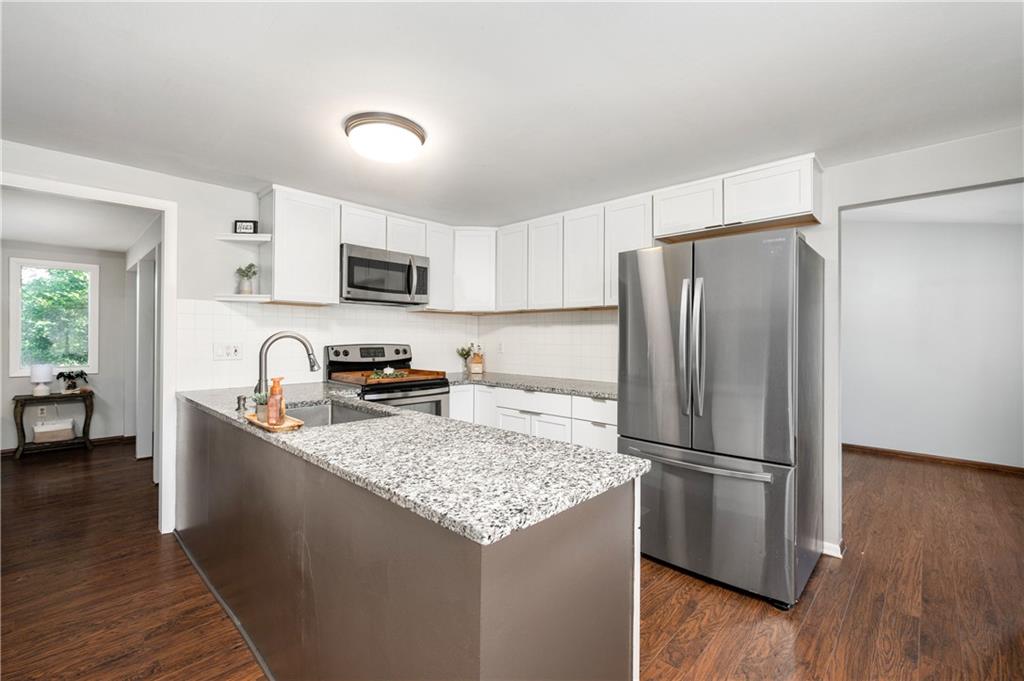 809 West Old Rte 422 Butler, PA 16001 - Photo 10 of 31 a kitchen with granite countertop a refrigerator and a stove top oven