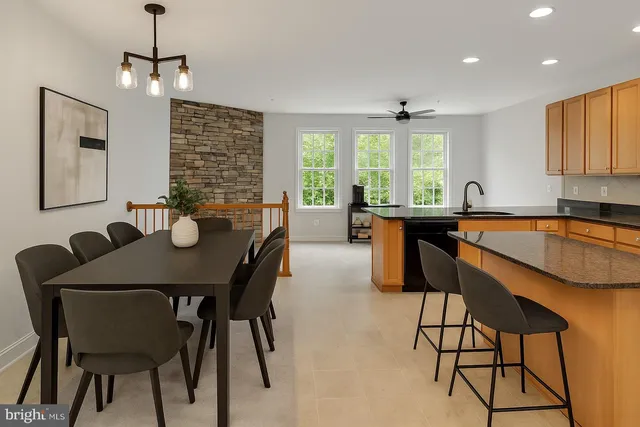 a dining room filled chandelier and wooden floor