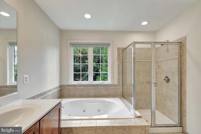 a bathroom with a bathtub and a shower
