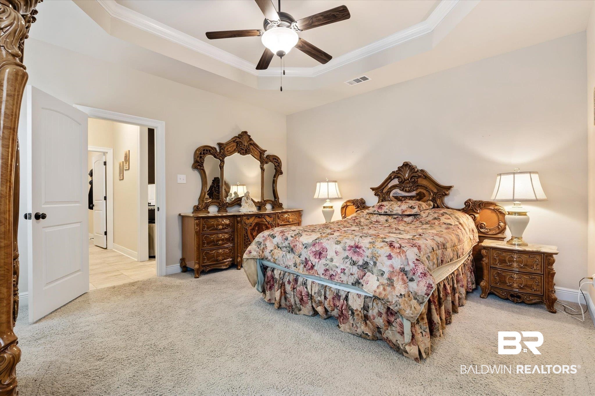 1786 Vivace Drive Foley, AL 36535 - Photo 11 of 21 Bedroom with crown molding, ceiling fan, carpet floors, and a tray ceiling
