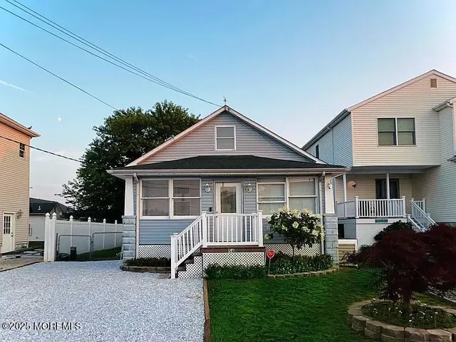 a view of a house with a yard and sitting area