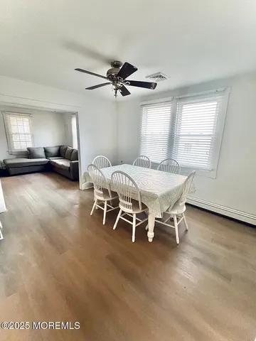a dining room with furniture and a window