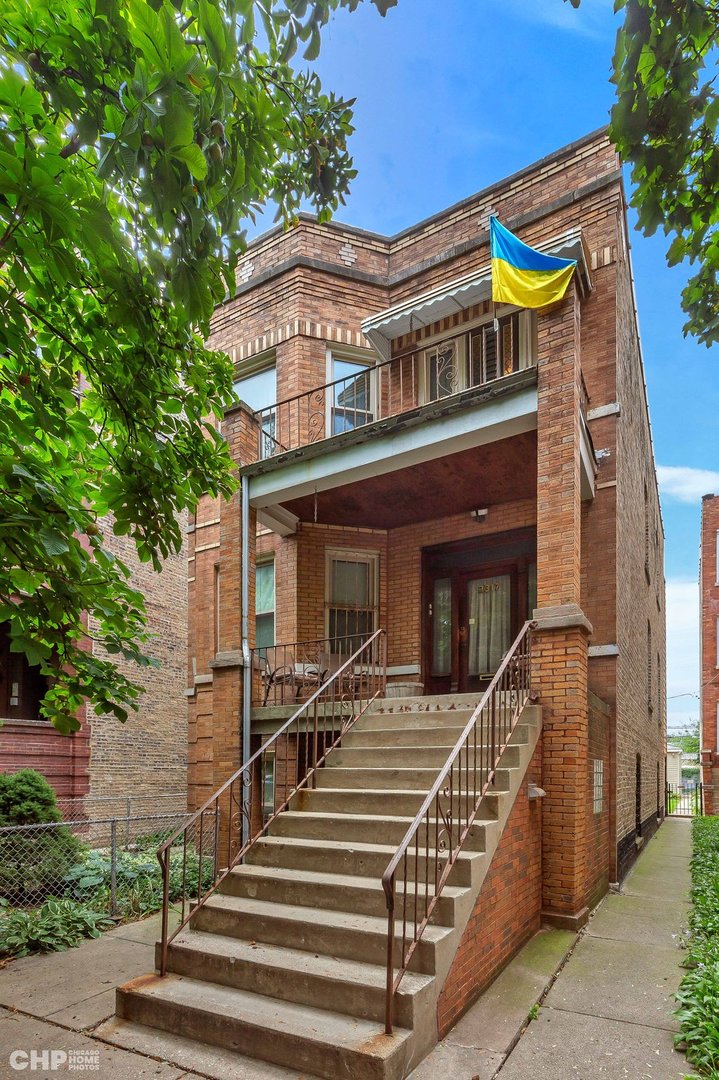 a front view of a house with stairs